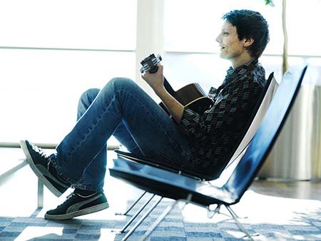 Guy waiting in Airport with guitar